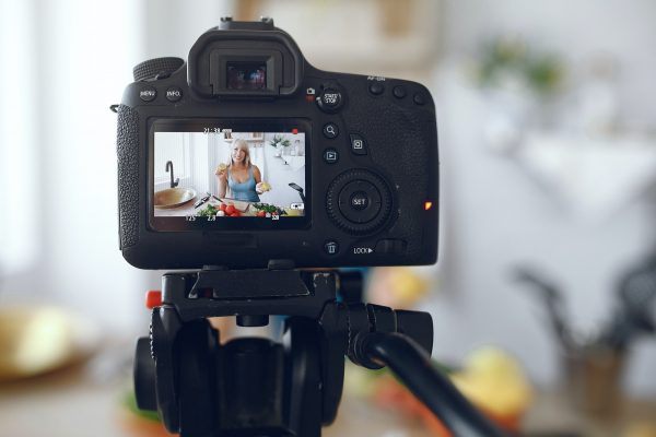 Beautiful and sporty girl in a kitchen recording a video Beautiful and sporty girl in a kitchen recording a video